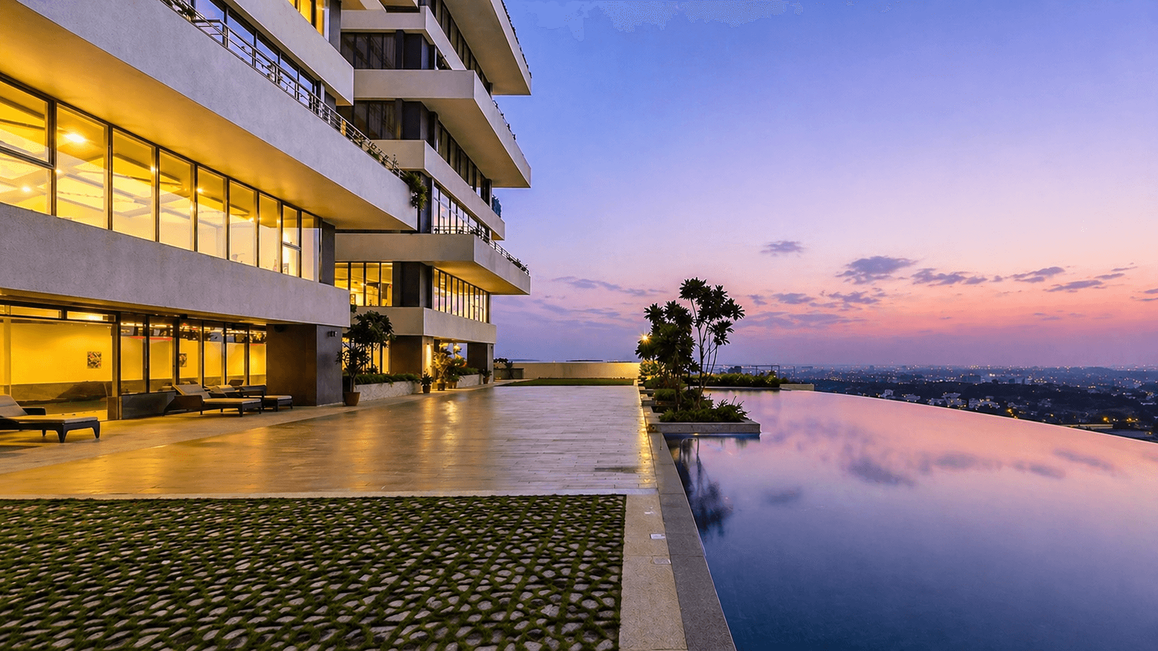 Rooftop infinity pool overlooking the Bengaluru skyline at dusk